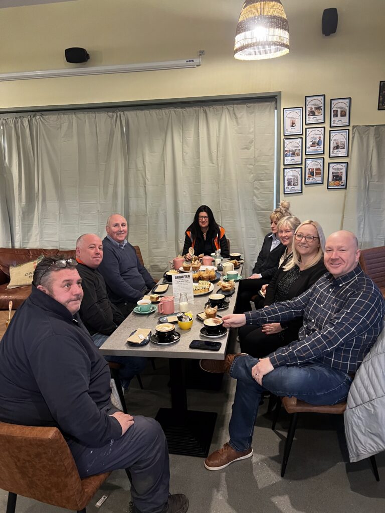 Robertson Construction and their suppliers at a table having coffees at Braw Tea Cafe